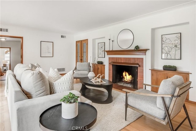 living room with a fireplace and light hardwood / wood-style floors