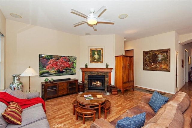 24238 Owl Ct, Corona, CA 92883 - living area with baseboards, a lit fireplace, wood finished floors, and a ceiling fan