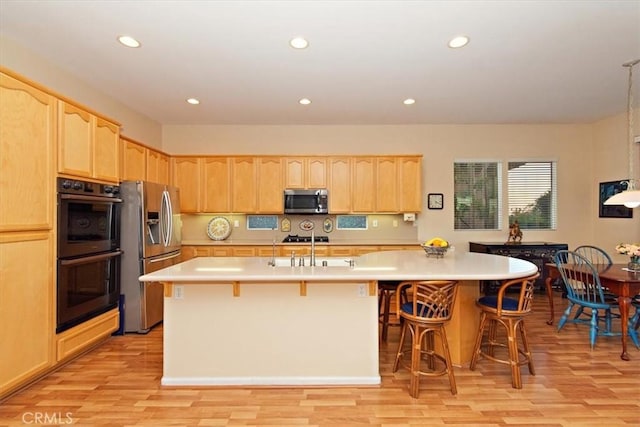 24238 Owl Ct, Corona, CA 92883 - kitchen with light brown cabinets, light countertops, a sink, and stainless steel appliances