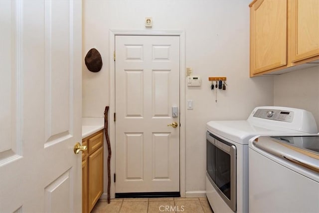 24238 Owl Ct, Corona, CA 92883 - clothes washing area with independent washer and dryer, cabinet space, and light tile patterned floors