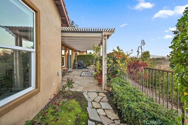 view of patio / terrace featuring a pergola and fence