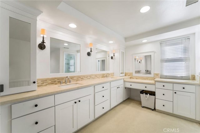 bathroom with tasteful backsplash and vanity