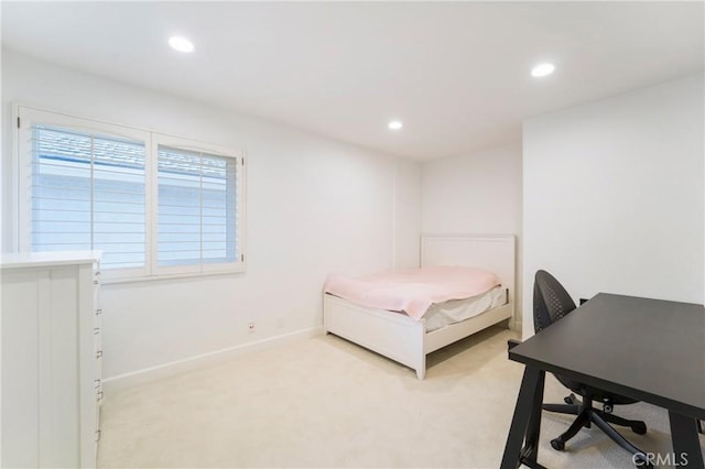 bedroom featuring light carpet