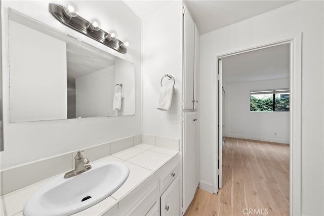 bathroom featuring hardwood / wood-style flooring and vanity