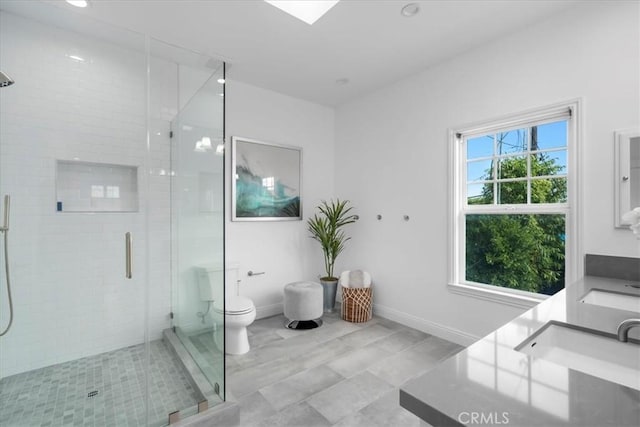 bathroom with vanity, toilet, and a shower with shower door