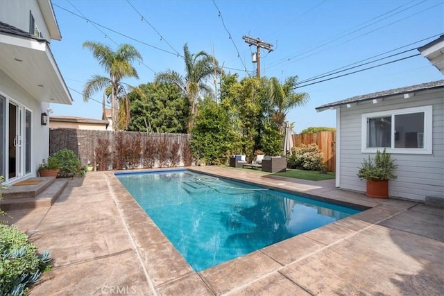 view of swimming pool featuring an outdoor living space and a patio area