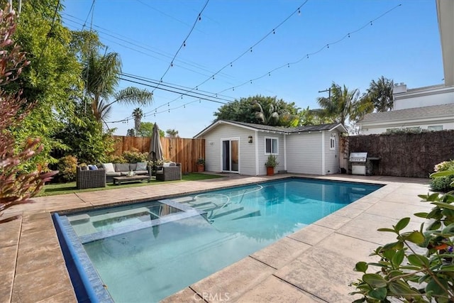 view of swimming pool with outdoor lounge area, an outdoor structure, and a patio area