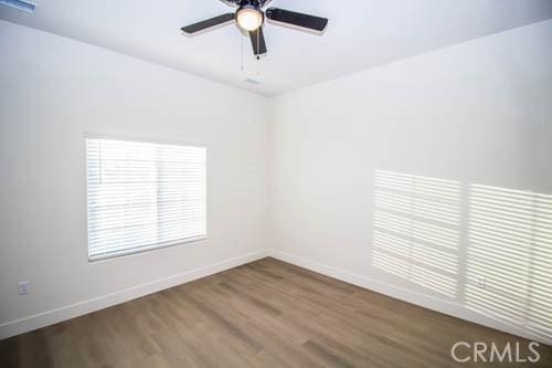 unfurnished room featuring hardwood / wood-style flooring and ceiling fan