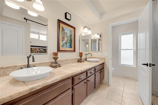 bathroom with vanity, a wealth of natural light, and toilet