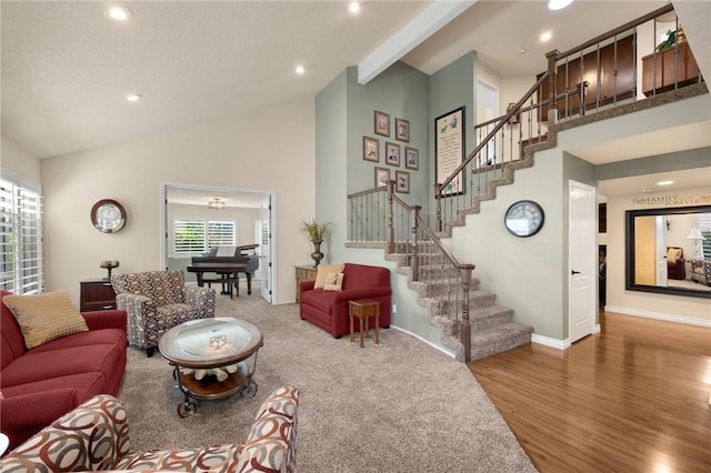 living room featuring wood-type flooring, high vaulted ceiling, and beamed ceiling