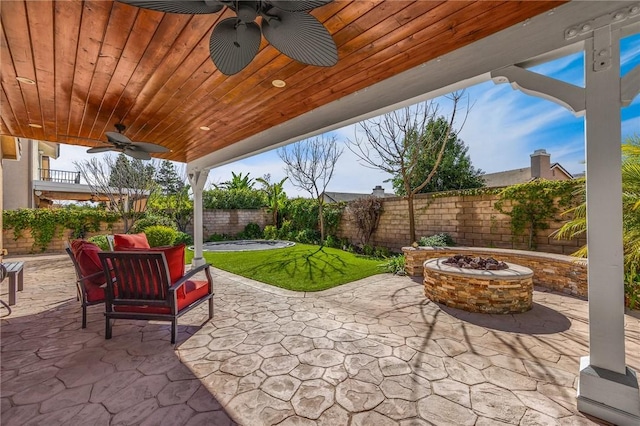 view of patio / terrace featuring a fire pit and ceiling fan