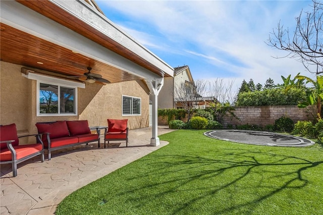 view of yard with ceiling fan, a patio, and a trampoline