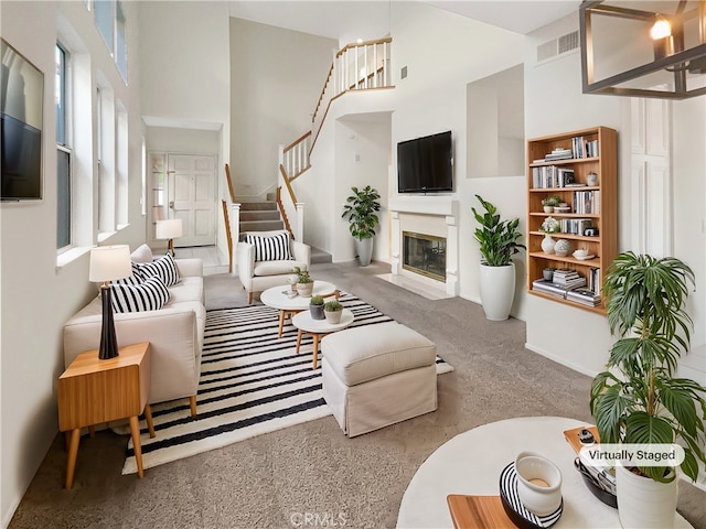 living room with a high ceiling and carpet