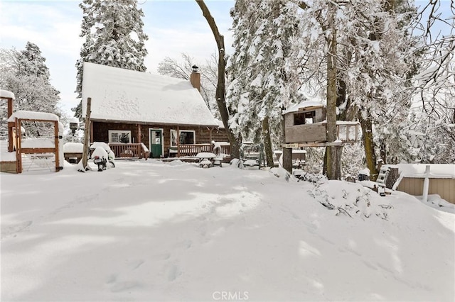 rustic home with a deck and a chimney