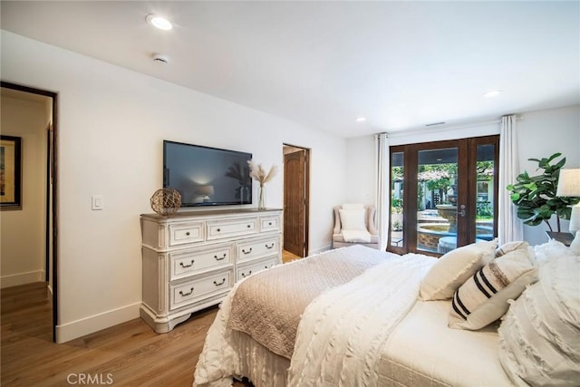 bedroom with recessed lighting, light wood-type flooring, baseboards, and access to outside