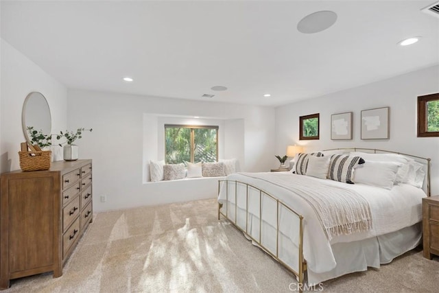 bedroom featuring recessed lighting, light colored carpet, and visible vents