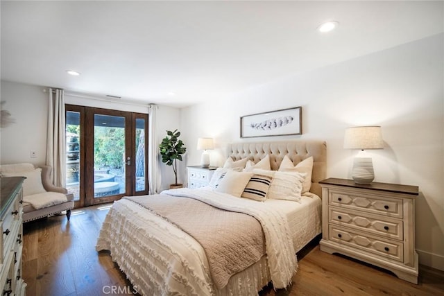 bedroom with access to exterior, recessed lighting, and wood finished floors