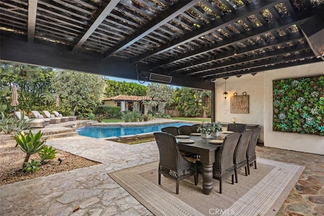 pool with a patio area, an outbuilding, outdoor dining space, and a pergola