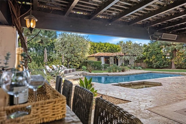 outdoor pool featuring fence, a hot tub, and a patio area