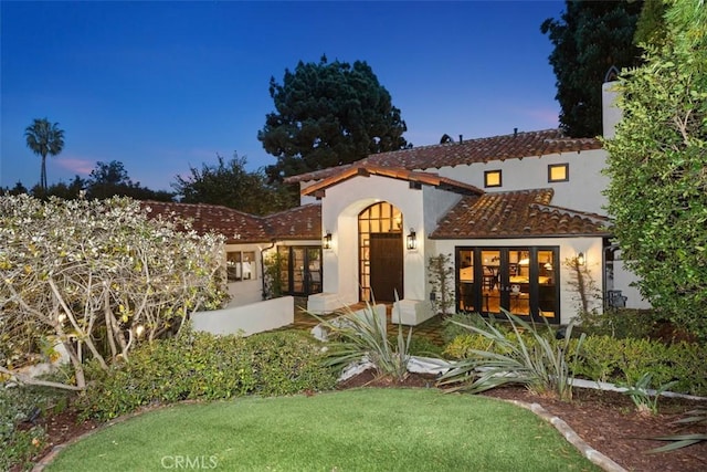 31872 Paseo Cielo, San Juan Capistrano, CA 92675 - mediterranean / spanish-style home with french doors, stucco siding, a tiled roof, and a lawn