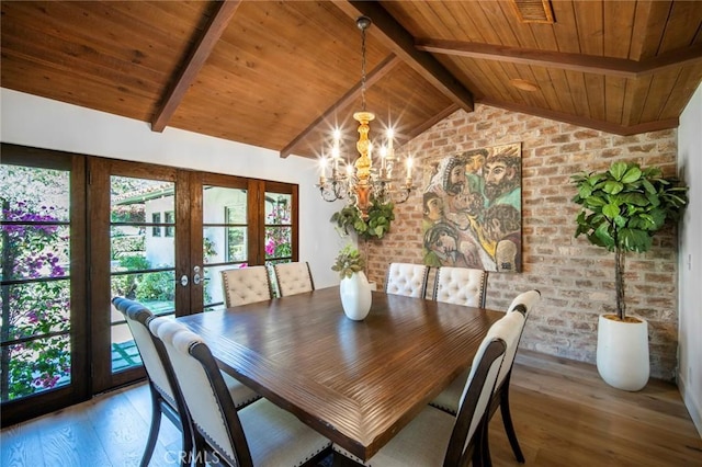 unfurnished dining area featuring a chandelier, wood ceiling, vaulted ceiling with beams, and light wood-type flooring