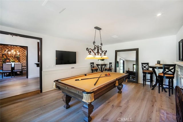 recreation room with wainscoting, billiards, and light wood-style floors