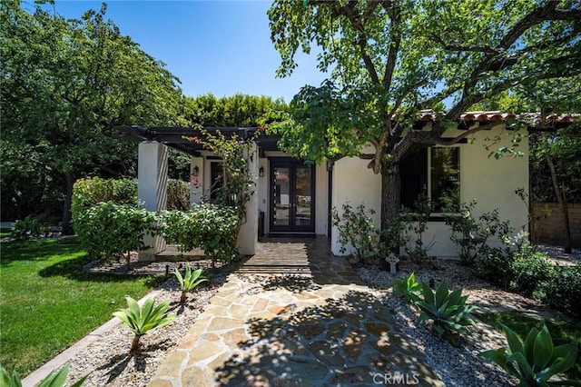 31872 Paseo Cielo, San Juan Capistrano, CA 92675 - view of exterior entry with stucco siding, a yard, and french doors
