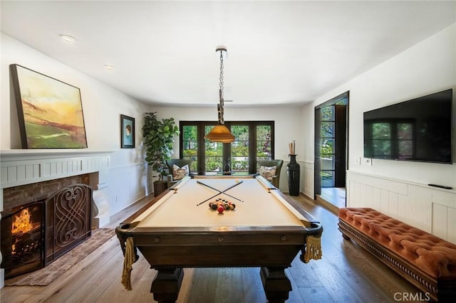 31872 Paseo Cielo, San Juan Capistrano, CA 92675 - playroom featuring wood finished floors, billiards table, a fireplace, and a wainscoted wall
