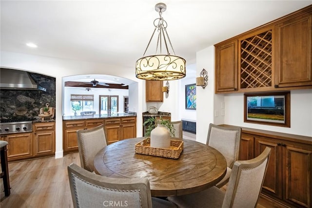 dining area featuring light wood-style flooring and a ceiling fan
