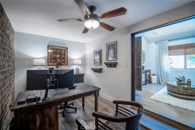 office area featuring wood finished floors, a ceiling fan, and baseboards