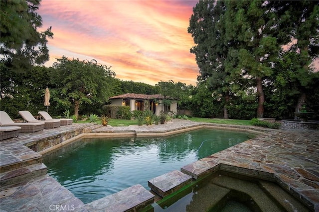 31872 Paseo Cielo, San Juan Capistrano, CA 92675 - pool at dusk featuring a patio, an outdoor structure, and a pool with connected hot tub