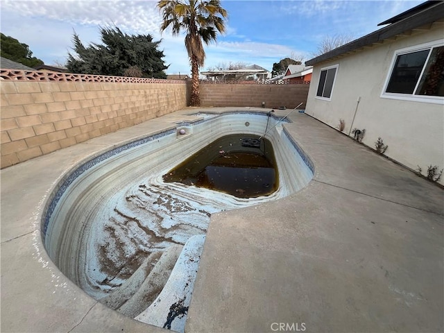 view of swimming pool with a fenced backyard