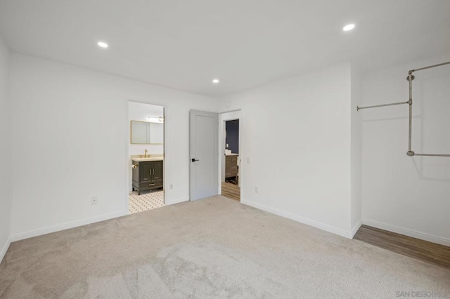 empty room featuring light carpet and sink