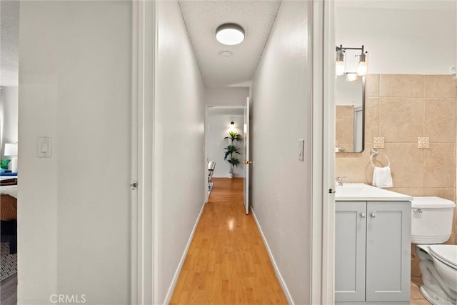 3565 Linden Ave Unit 220, Long Beach, CA 90807 - corridor featuring light wood-style flooring and tile walls