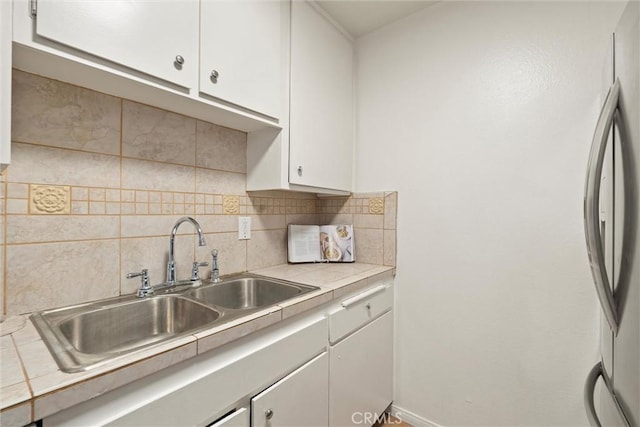 3565 Linden Ave Unit 220, Long Beach, CA 90807 - kitchen with stainless steel refrigerator, white cabinets, and tasteful backsplash