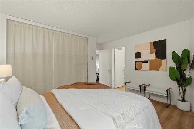 3565 Linden Ave Unit 220, Long Beach, CA 90807 - bedroom with wood finished floors and a textured ceiling