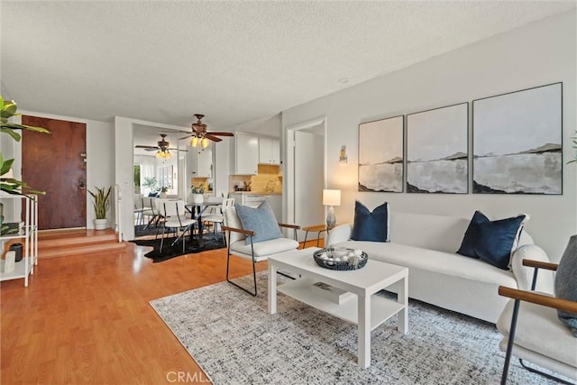3565 Linden Ave Unit 220, Long Beach, CA 90807 - living area with light wood finished floors, a textured ceiling, and a ceiling fan
