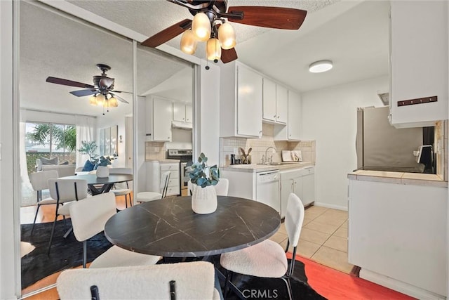 3565 Linden Ave Unit 220, Long Beach, CA 90807 - dining room featuring ceiling fan, light tile patterned floors, and a textured ceiling