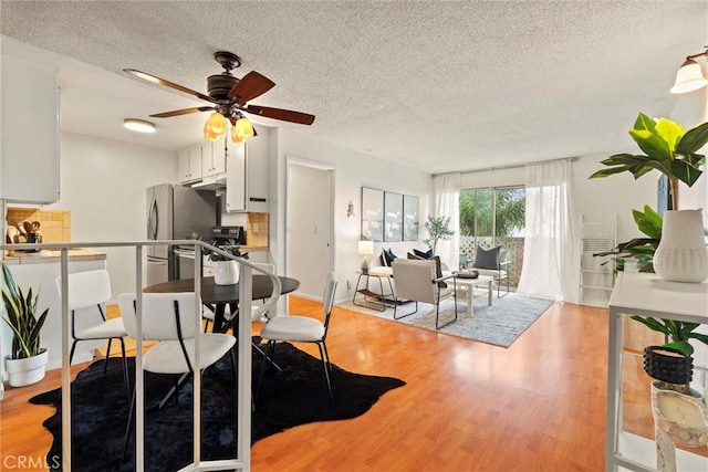 3565 Linden Ave Unit 220, Long Beach, CA 90807 - dining space with a textured ceiling, light wood-style flooring, and a ceiling fan