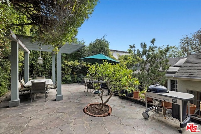 view of patio featuring area for grilling and a pergola