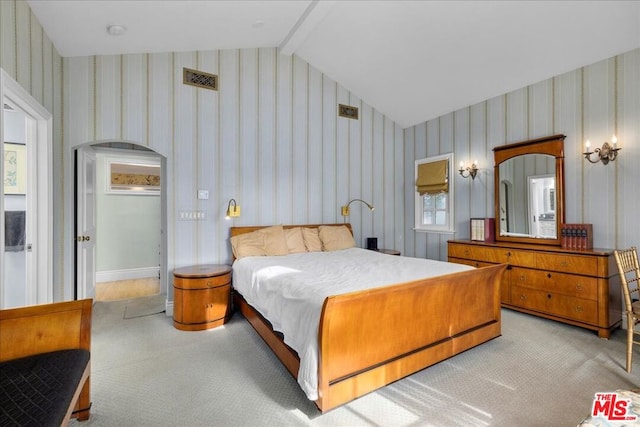 bedroom with light carpet and lofted ceiling with beams