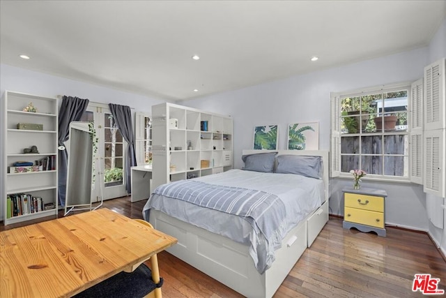 bedroom with dark hardwood / wood-style floors