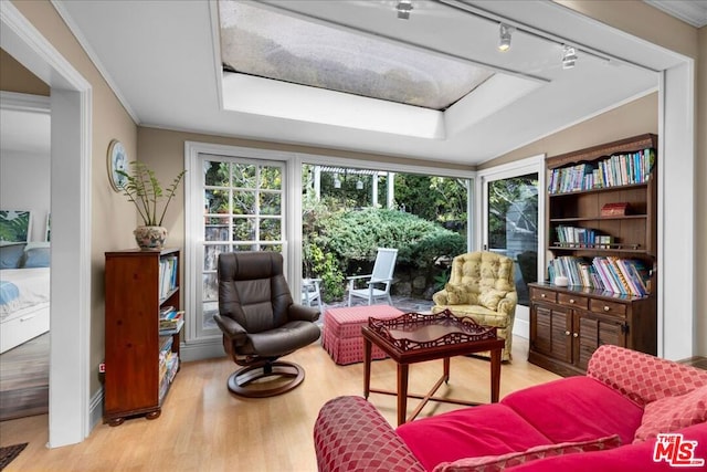 living area featuring crown molding, track lighting, and light hardwood / wood-style floors