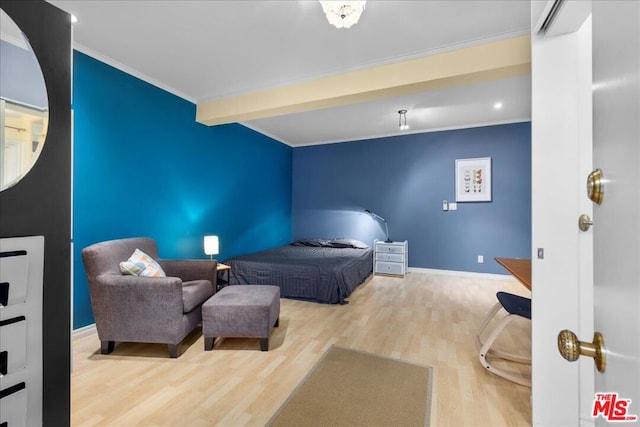 bedroom with hardwood / wood-style flooring and crown molding