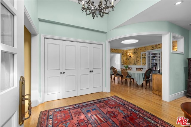 foyer featuring a notable chandelier and wood-type flooring