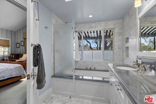 bathroom with vanity and independent shower and bath