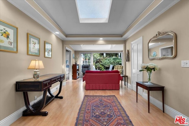 corridor with a skylight and light hardwood / wood-style floors