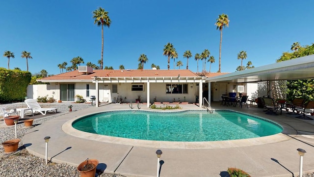 view of swimming pool featuring a patio and central air condition unit