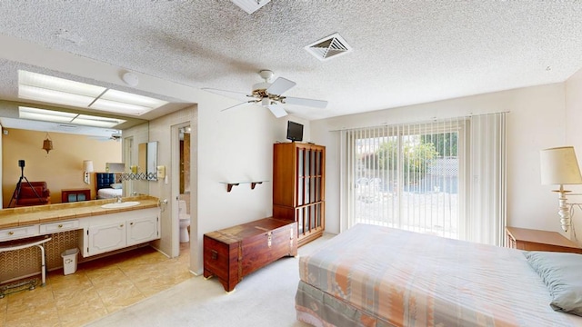 bedroom featuring sink, ceiling fan, access to exterior, a textured ceiling, and light colored carpet