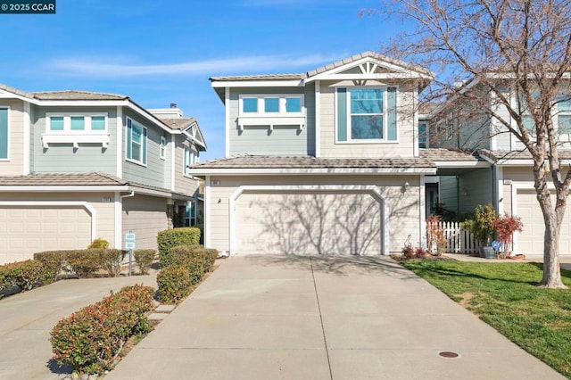 view of front of house featuring a garage and a front lawn